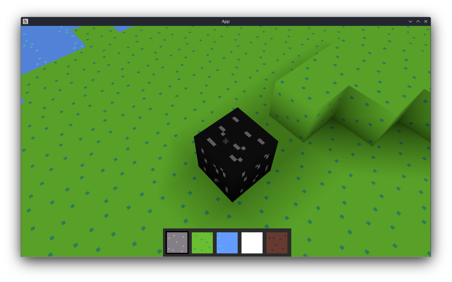 A single lonely black bedrock block, as used in the first challenge, contrasted against the grassy ground.